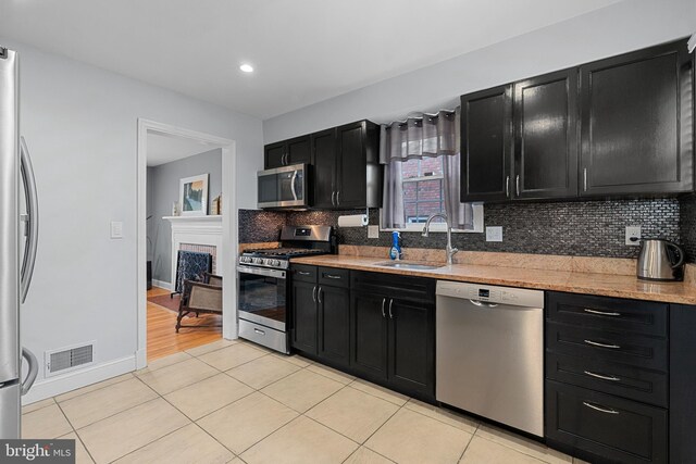 304 Moncure Dr, Alexandria, VA 22314 - kitchen with a sink, visible vents, light tile patterned floors, dark cabinetry, and appliances with stainless steel finishes