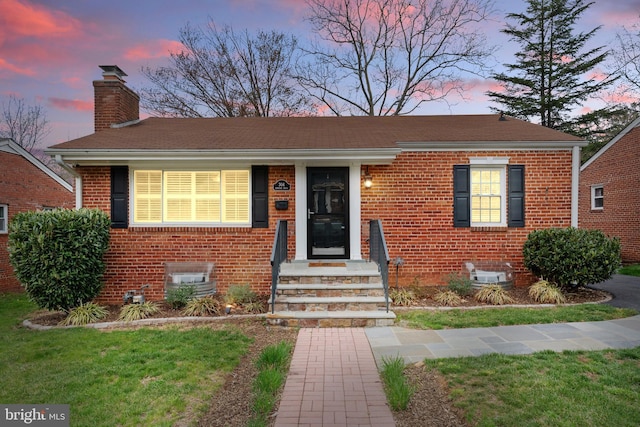 304 Moncure Dr, Alexandria, VA 22314 - view of front of house with a chimney, a front yard, and brick siding