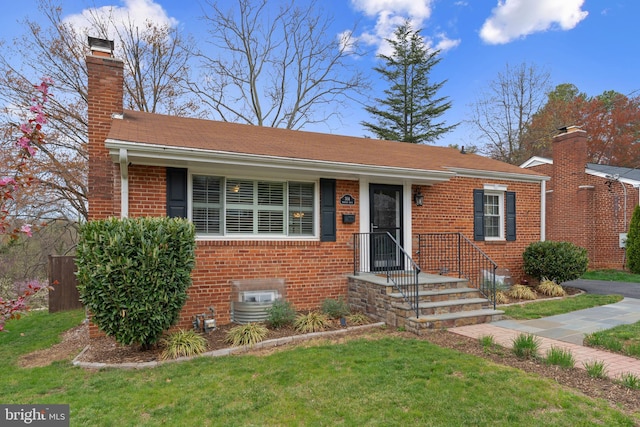 304 Moncure Dr, Alexandria, VA 22314 - view of front of home with a front lawn, brick siding, and a chimney