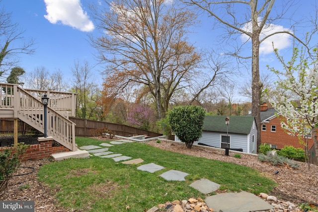 304 Moncure Dr, Alexandria, VA 22314 - view of yard featuring a deck, stairs, fence, and an outbuilding