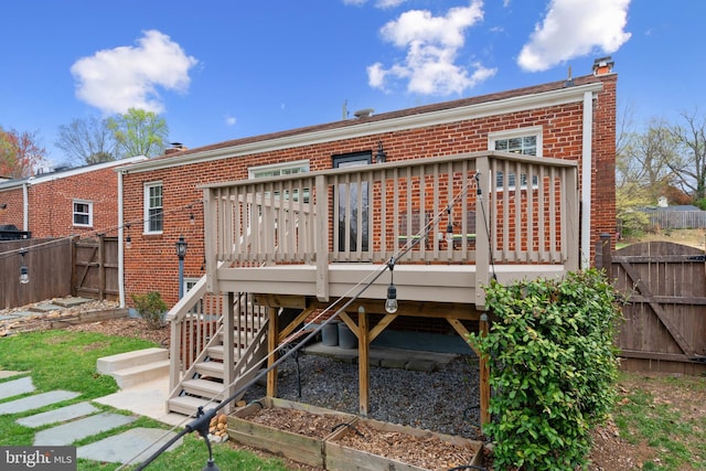 304 Moncure Dr, Alexandria, VA 22314 - rear view of property with brick siding, a gate, a chimney, and a wooden deck