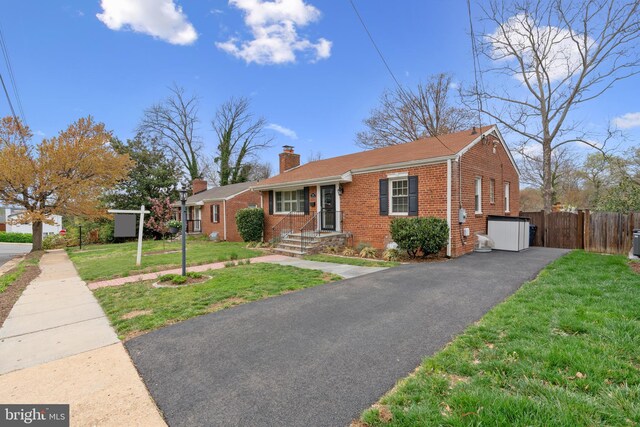304 Moncure Dr, Alexandria, VA 22314 - ranch-style house featuring fence, brick siding, driveway, a front yard, and a chimney