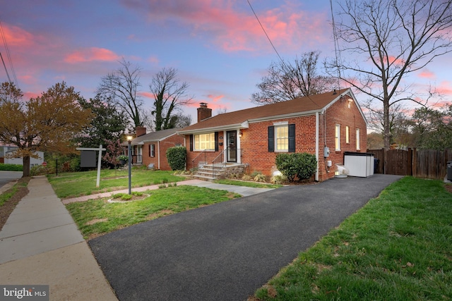 304 Moncure Dr, Alexandria, VA 22314 - ranch-style home featuring a chimney, a lawn, fence, aphalt driveway, and brick siding