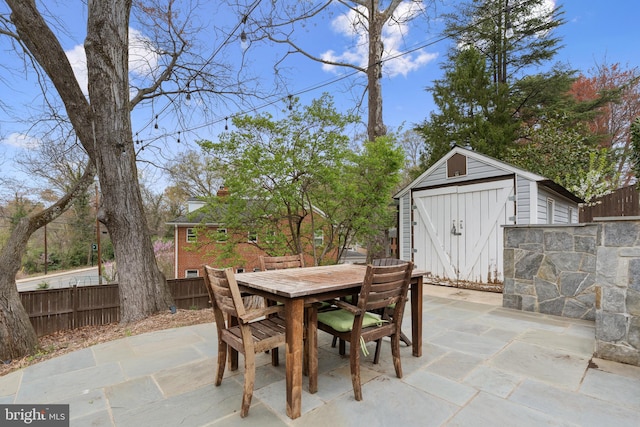 304 Moncure Dr, Alexandria, VA 22314 - view of patio featuring an outbuilding, a shed, outdoor dining area, and fence