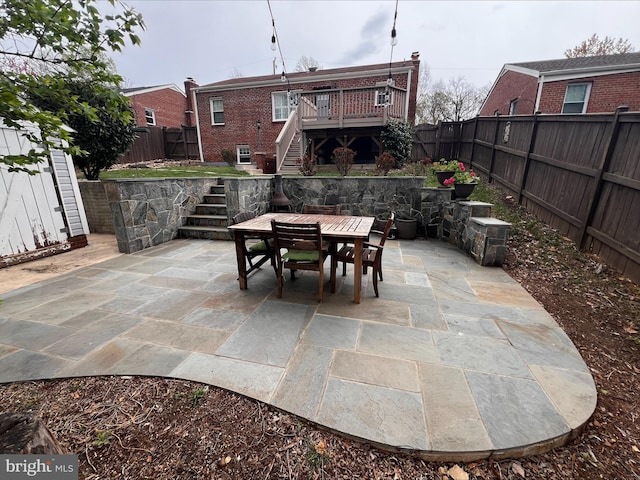304 Moncure Dr, Alexandria, VA 22314 - view of patio featuring a fenced backyard, stairs, outdoor dining area, and a deck