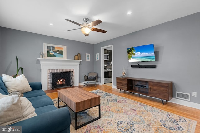 304 Moncure Dr, Alexandria, VA 22314 - living room featuring wood finished floors, visible vents, a fireplace, a ceiling fan, and baseboards