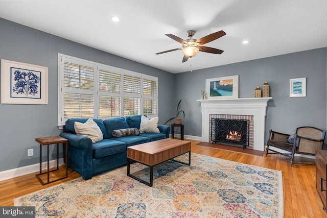 304 Moncure Dr, Alexandria, VA 22314 - living room featuring light wood finished floors, a brick fireplace, baseboards, ceiling fan, and recessed lighting