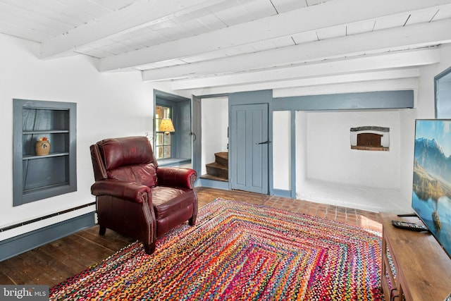 living area with stairs, beam ceiling, and wood finished floors