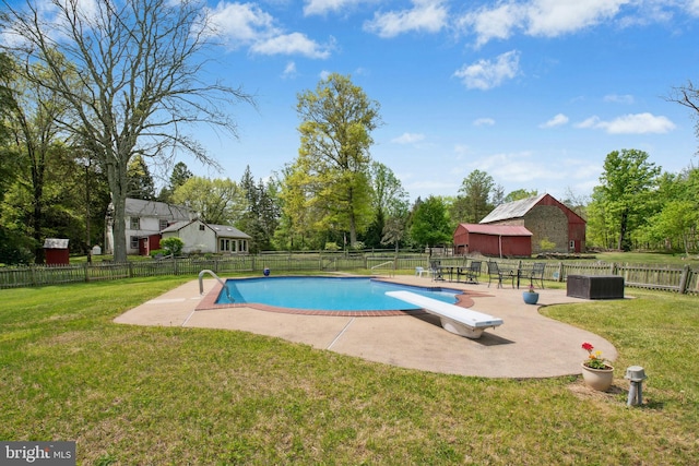 view of swimming pool with a lawn, a patio, a fenced in pool, and fence