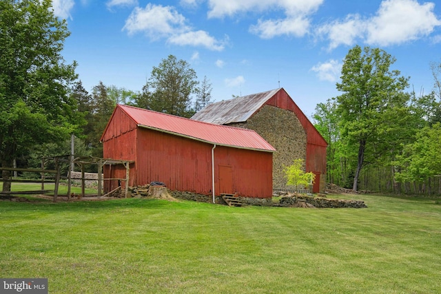 view of pole building featuring a yard and fence