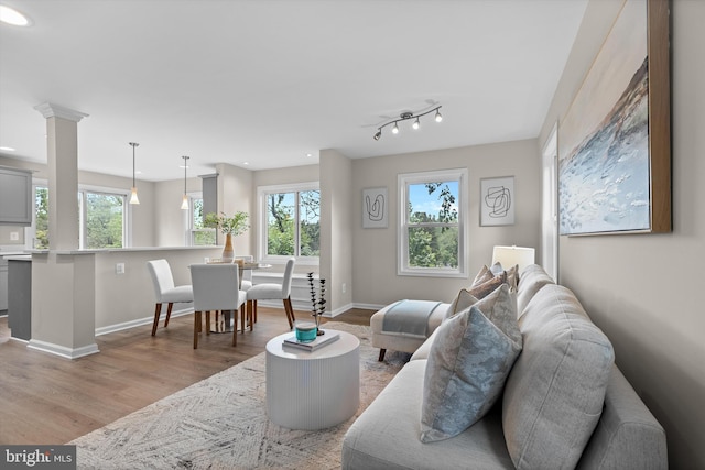 living area with light wood-style flooring, healthy amount of natural light, baseboards, and recessed lighting