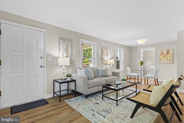 living area with wood finished floors and baseboards