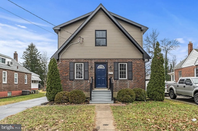 22 Duncan Ave, Westville, NJ 08093 - view of front of house featuring brick siding, a front yard, and cooling unit