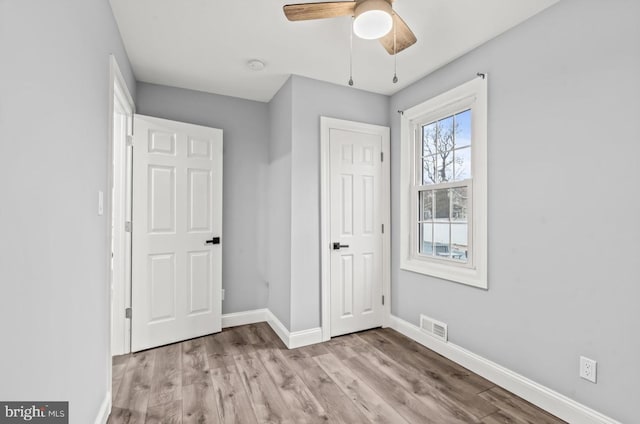 22 Duncan Ave, Westville, NJ 08093 - unfurnished bedroom featuring baseboards, wood finished floors, and a ceiling fan