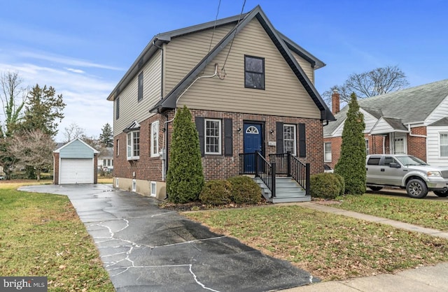 22 Duncan Ave, Westville, NJ 08093 - view of front of home with brick siding, an outbuilding, a garage, driveway, and a front yard