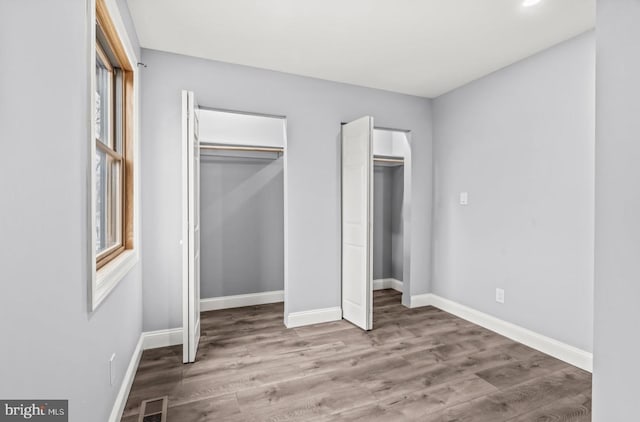 22 Duncan Ave, Westville, NJ 08093 - unfurnished bedroom with wood finished floors, multiple closets, and baseboards