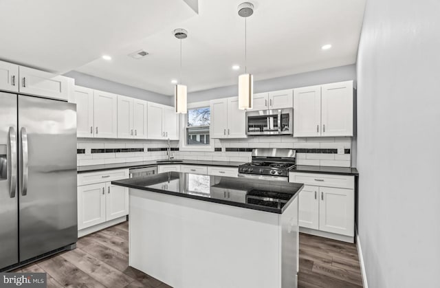 22 Duncan Ave, Westville, NJ 08093 - kitchen featuring appliances with stainless steel finishes, a sink, white cabinets, backsplash, and recessed lighting