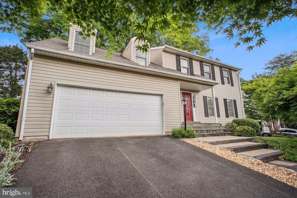 11444 Tanbark Dr, Reston, VA 20191 - traditional-style house featuring driveway, an attached garage, and roof with shingles