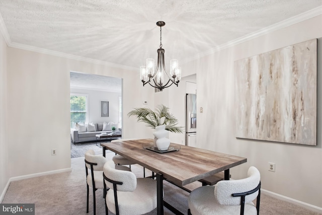 carpeted dining room with a chandelier, baseboards, ornamental molding, and a textured ceiling