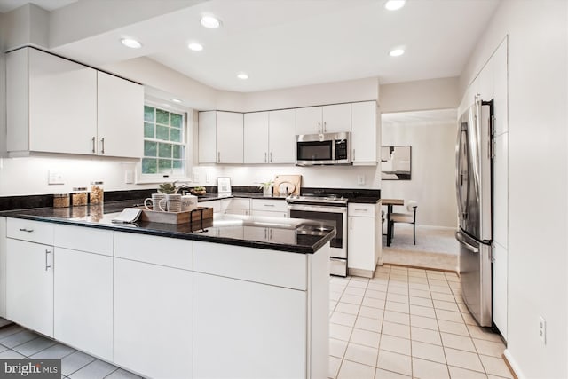 kitchen featuring stainless steel appliances, a peninsula, light tile patterned floors, white cabinets, and recessed lighting