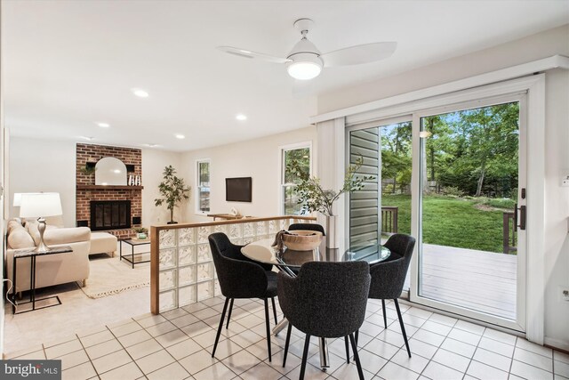 dining area featuring ceiling fan, recessed lighting, a fireplace, and light tile patterned floors
