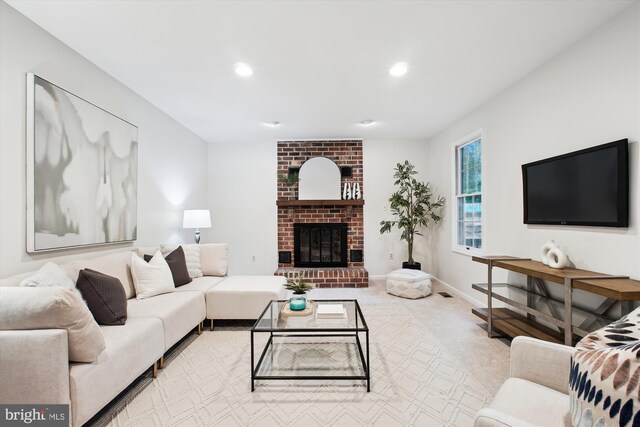 carpeted living room featuring recessed lighting and a brick fireplace