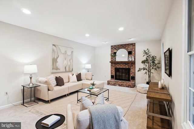 carpeted living area with a brick fireplace, recessed lighting, and baseboards