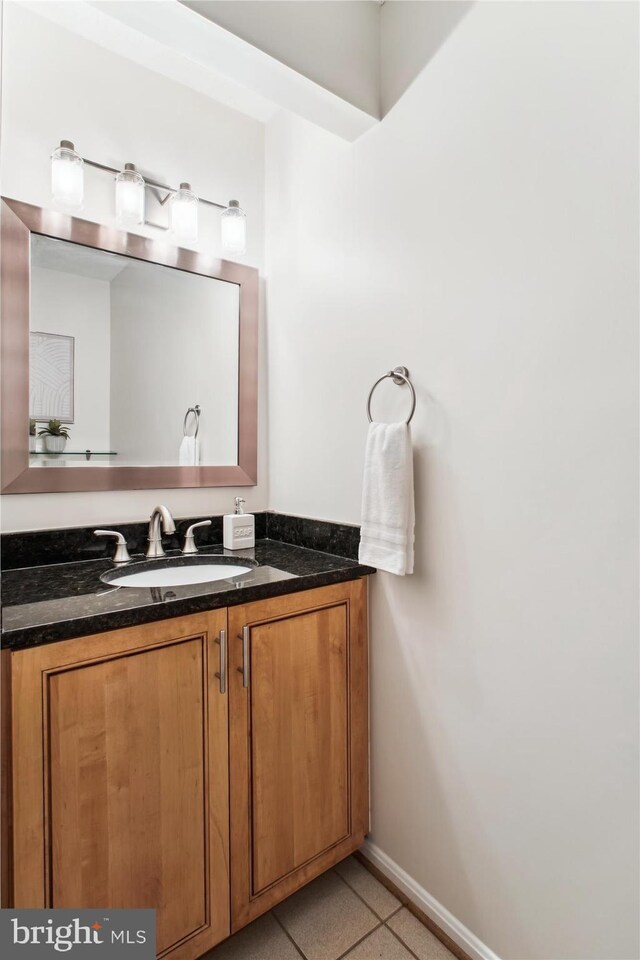 bathroom featuring baseboards and vanity
