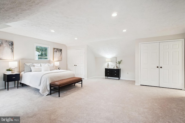 carpeted bedroom featuring baseboards, recessed lighting, and a textured ceiling