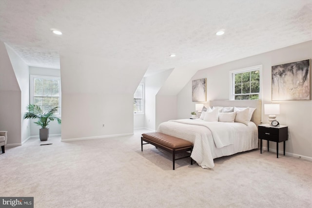 bedroom with carpet, multiple windows, recessed lighting, and lofted ceiling