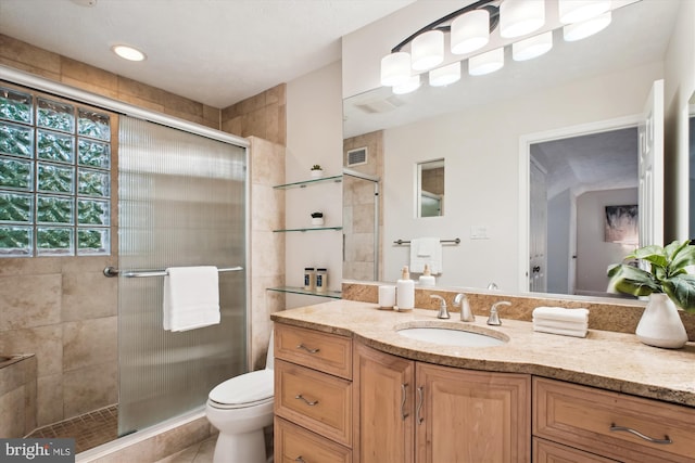 full bath with a stall shower, vanity, toilet, and tile patterned flooring