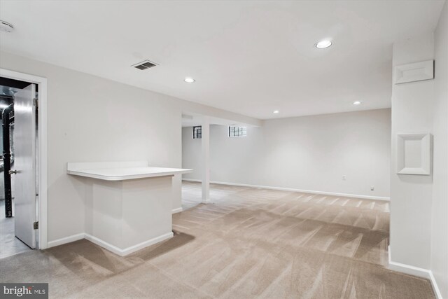 empty room with light colored carpet, recessed lighting, baseboards, and a smoke detector