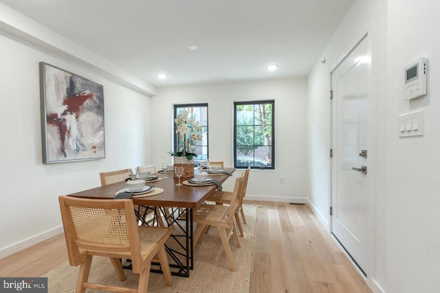 dining room featuring recessed lighting, baseboards, and light wood-style floors