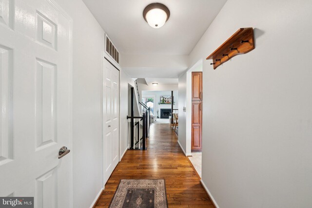 hall featuring wood finished floors and baseboards