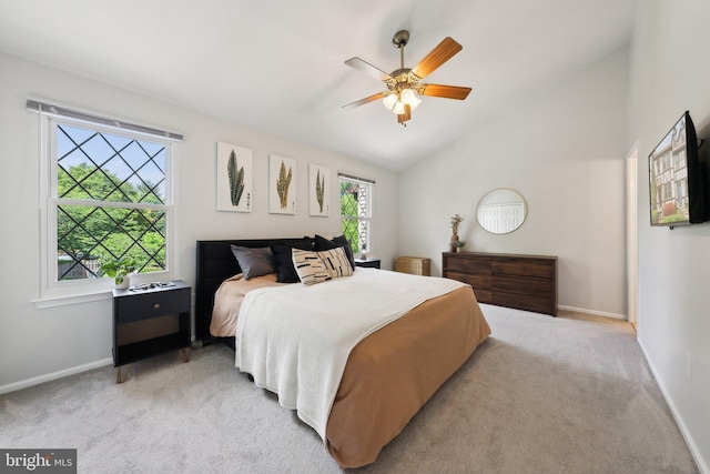 bedroom with light carpet, baseboards, lofted ceiling, and a ceiling fan