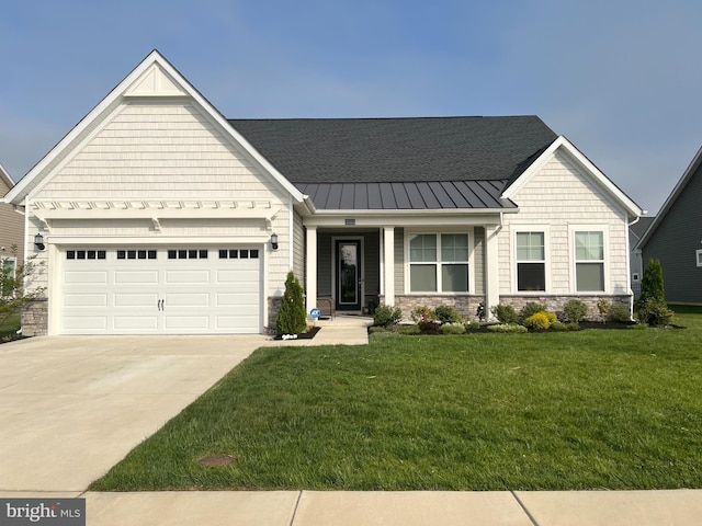35015 Kindleton Ln, Lewes, DE 19958 - craftsman-style house featuring stone siding, concrete driveway, a standing seam roof, a front lawn, and an attached garage