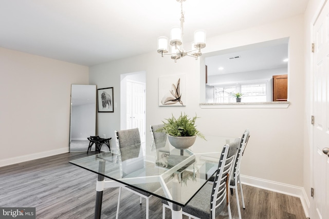 1020 Thomas Rd, Glen Burnie, MD 21060 - dining room featuring a chandelier, wood finished floors, and baseboards