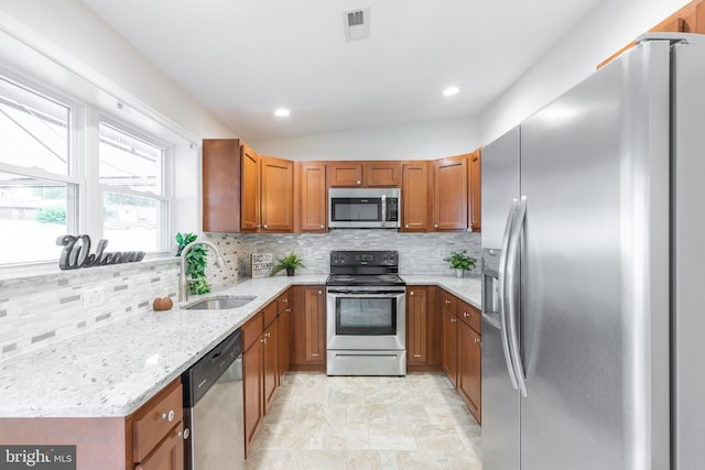 1020 Thomas Rd, Glen Burnie, MD 21060 - kitchen with stainless steel appliances, a sink, brown cabinetry, tasteful backsplash, and recessed lighting