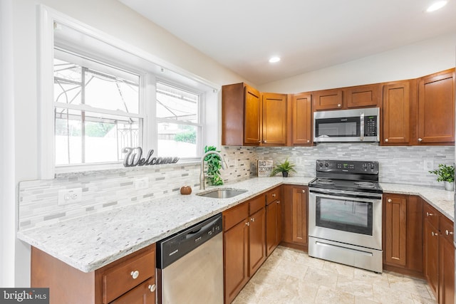 1020 Thomas Rd, Glen Burnie, MD 21060 - kitchen featuring stainless steel appliances, a sink, light stone counters, tasteful backsplash, and recessed lighting