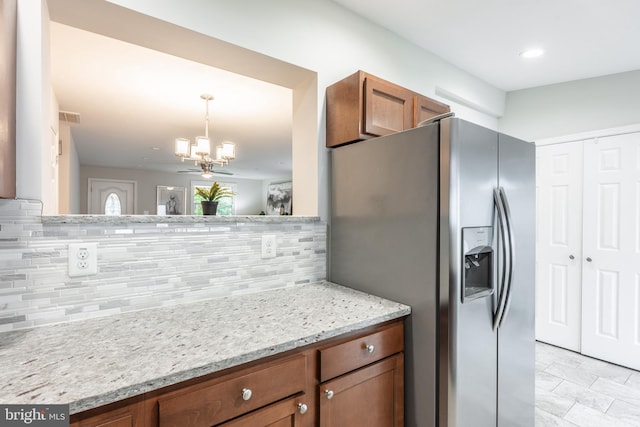 1020 Thomas Rd, Glen Burnie, MD 21060 - kitchen featuring stainless steel fridge, brown cabinetry, a chandelier, and tasteful backsplash