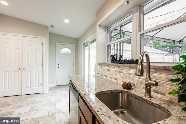 1020 Thomas Rd, Glen Burnie, MD 21060 - kitchen featuring a sink, stainless steel dishwasher, decorative backsplash, plenty of natural light, and lofted ceiling