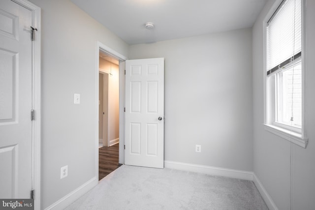 1020 Thomas Rd, Glen Burnie, MD 21060 - unfurnished bedroom with carpet flooring, baseboards, and multiple windows