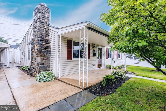 1020 Thomas Rd, Glen Burnie, MD 21060 - view of front of house featuring a porch, a front lawn, and a chimney