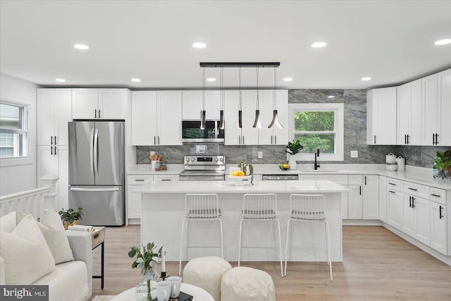 8224 Old Mill Rd, Pasadena, MD 21122 - kitchen featuring stainless steel appliances, a kitchen island, backsplash, white cabinetry, and recessed lighting