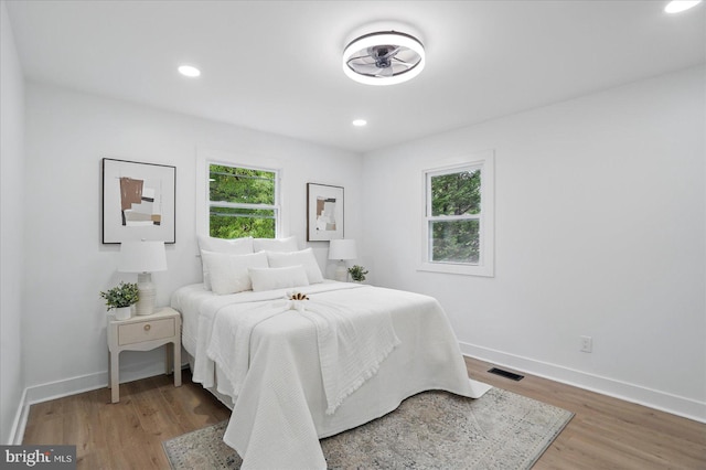 8224 Old Mill Rd, Pasadena, MD 21122 - bedroom featuring multiple windows, wood finished floors, baseboards, and recessed lighting