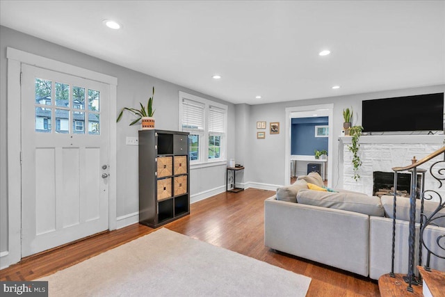 628 Mason Ave, Drexel Hill, PA 19026 - living area with wood finished floors, recessed lighting, a stone fireplace, and baseboards