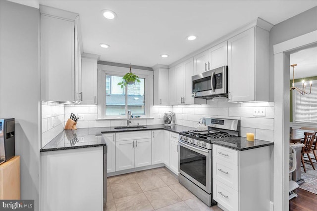 628 Mason Ave, Drexel Hill, PA 19026 - kitchen featuring stainless steel appliances, a sink, white cabinets, backsplash, and recessed lighting