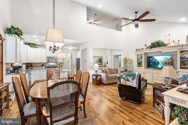 606 Garden Gate Dr, Middletown, DE 19709 - dining space with a ceiling fan, light wood-style floors, a chandelier, high vaulted ceiling, and recessed lighting