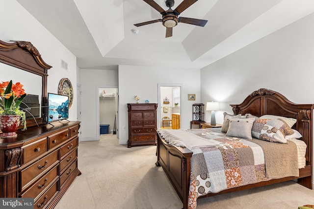 606 Garden Gate Dr, Middletown, DE 19709 - bedroom with a raised ceiling, light carpet, a spacious closet, connected bathroom, and ceiling fan