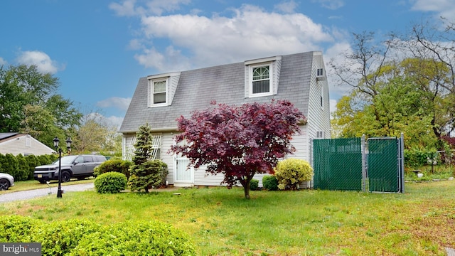 view of property exterior featuring a lawn and fence